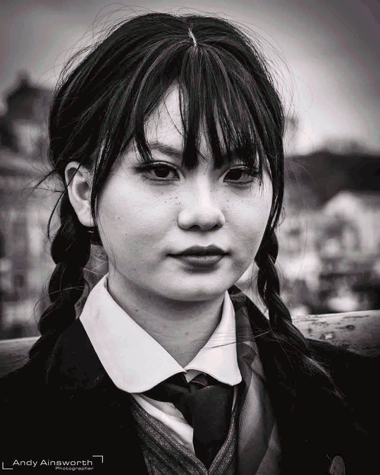 Young woman in plaited pigtails, school-style shirt and tie, black and white — Whitby Goth Weekend