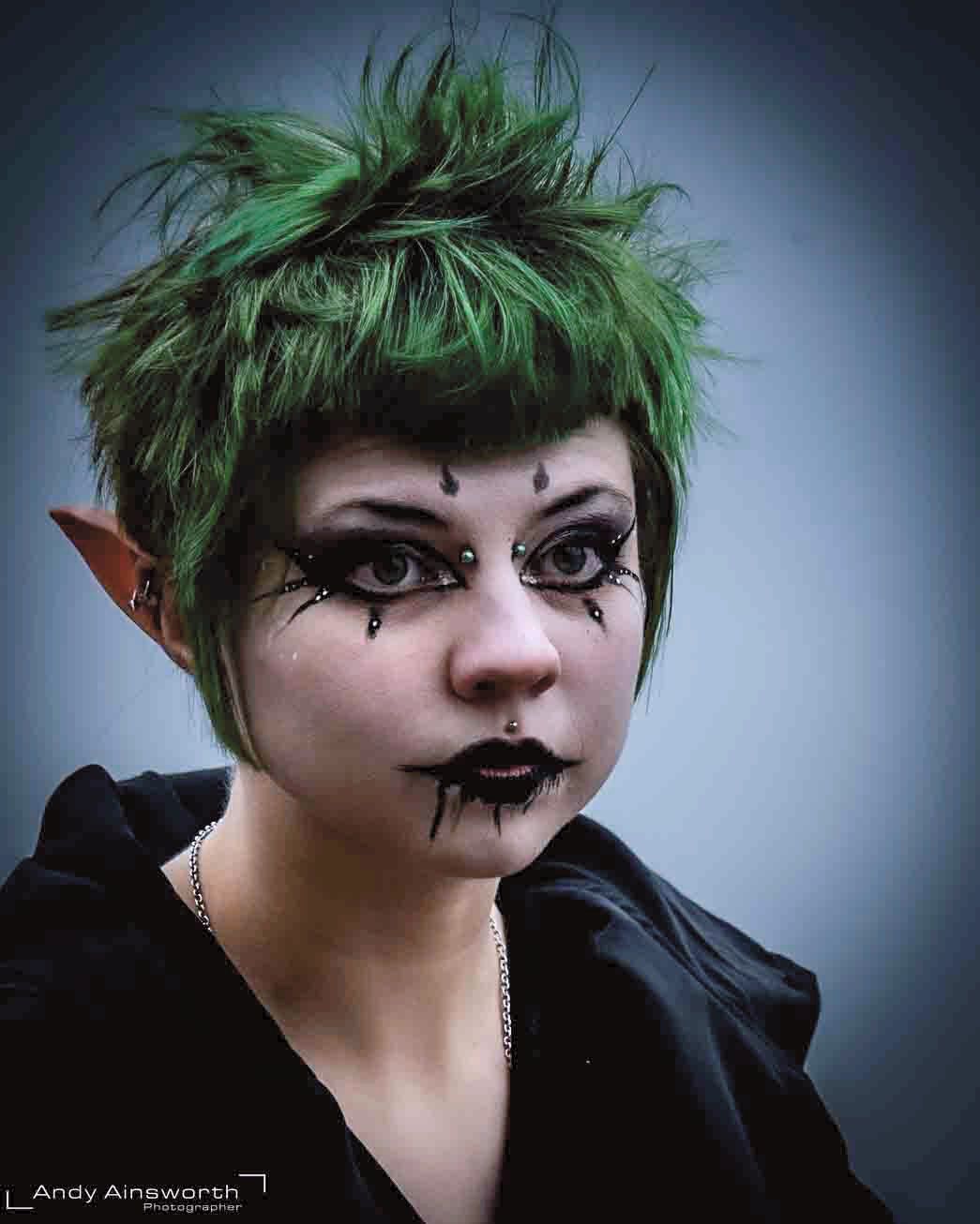 Young woman with spiked green hair, pointed ears and dramatic black eye make-up — Whitby Goth Weekend