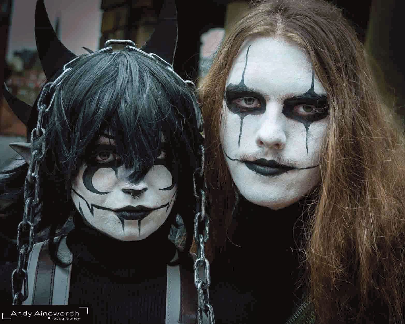 Two friends in black-and-white corpse paint, one horned and chained — Whitby Goth Weekend