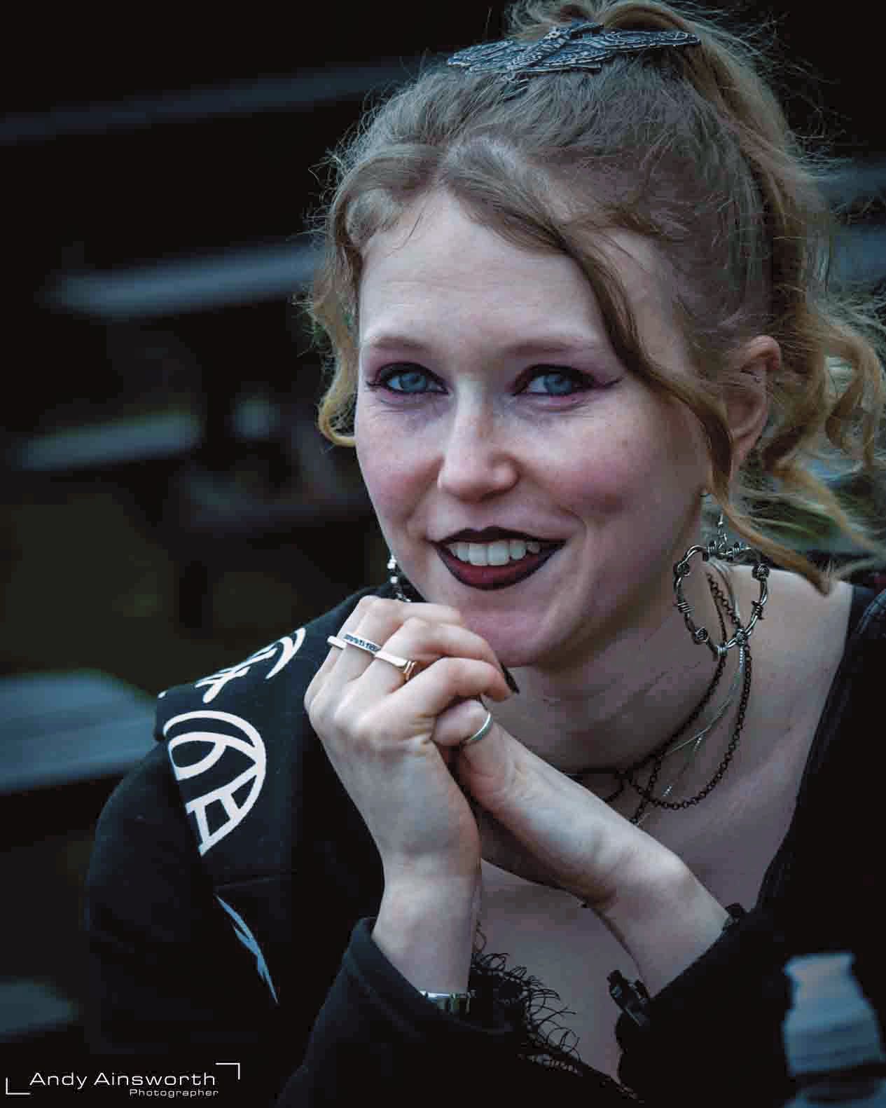 Laughing young woman with black lipstick, silver rings and hands clasped — Whitby Goth Weekend