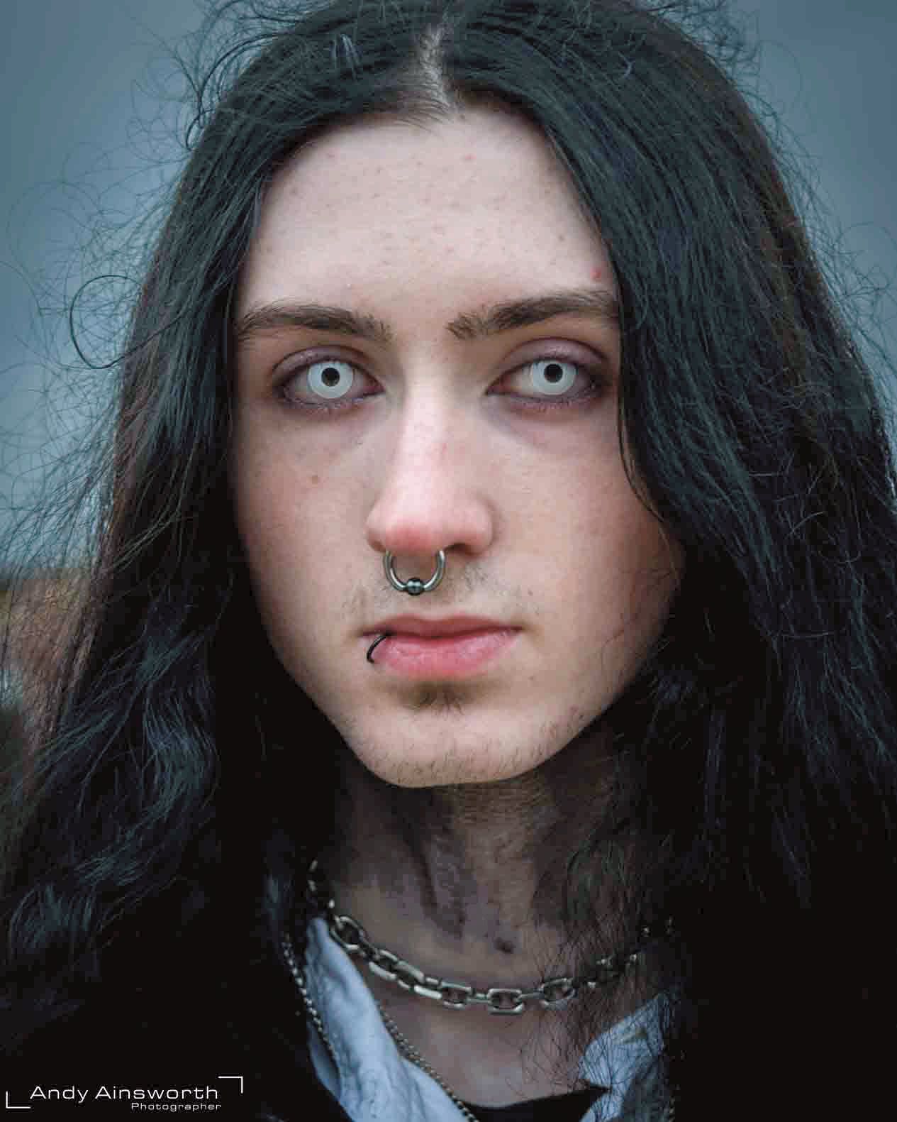 Young man with long black hair, pale contact lenses and a septum ring — Whitby Goth Weekend