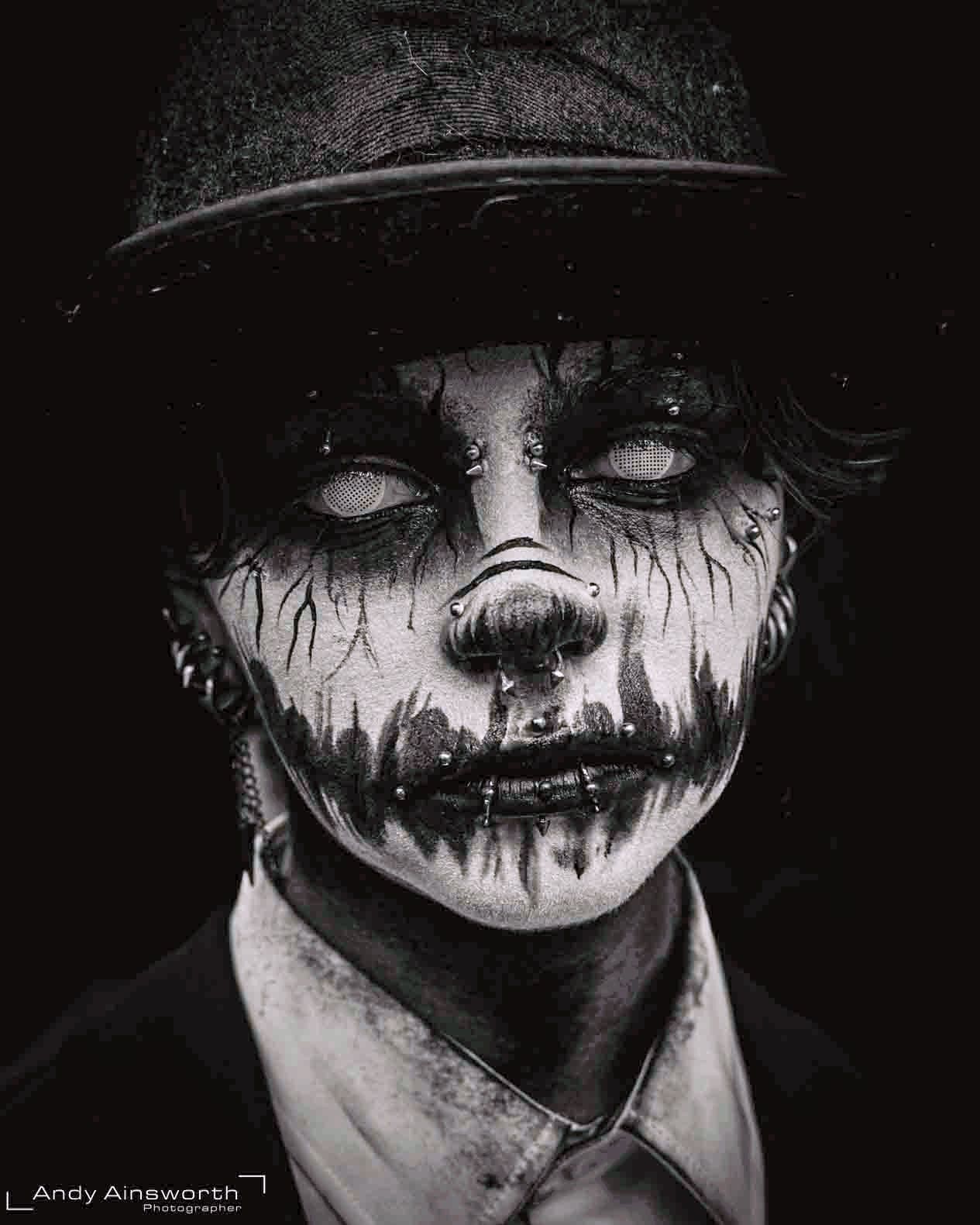 White-eyed painted face streaked with dark drips beneath a bowler hat, black and white — Whitby Goth Weekend