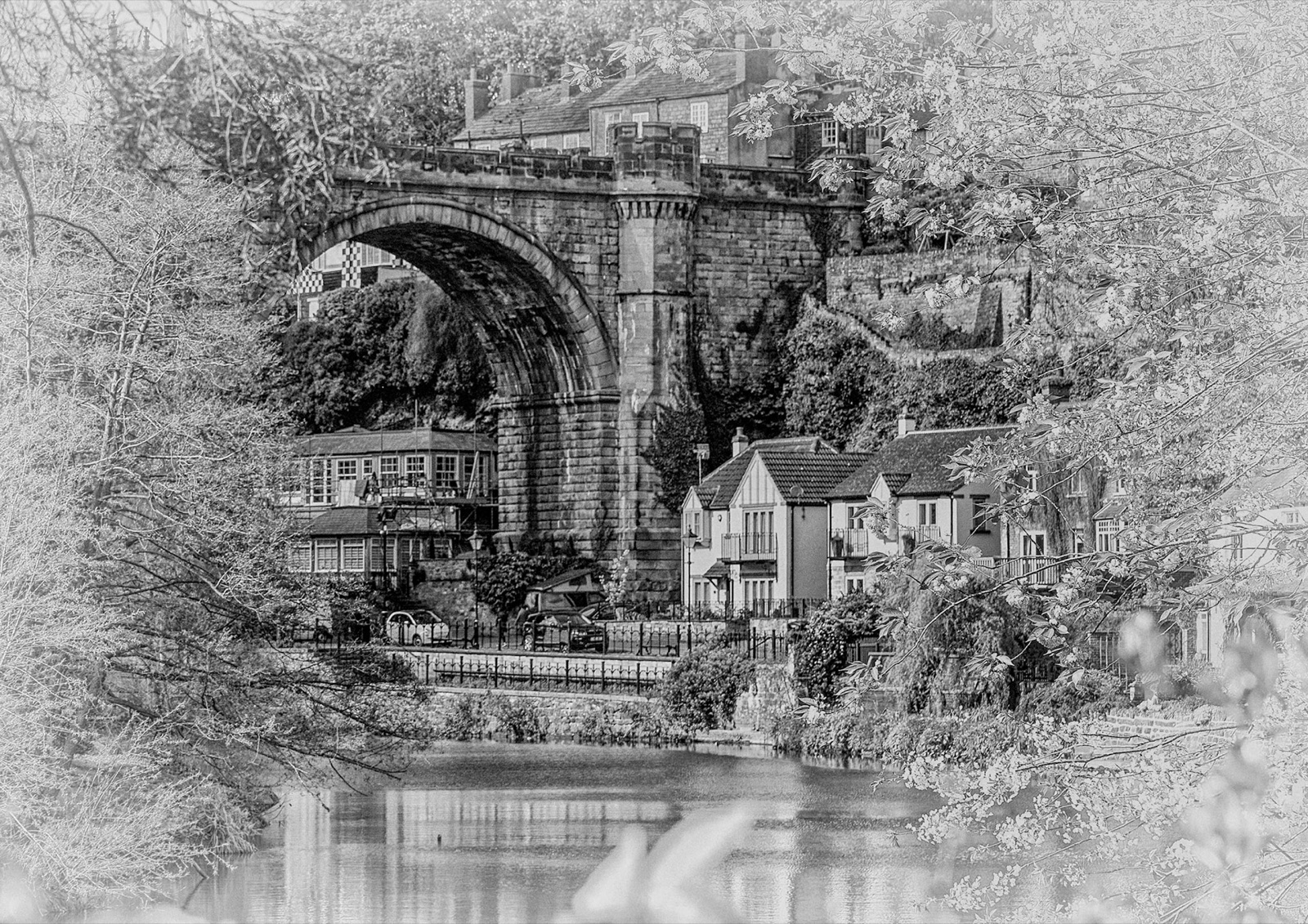 Viaduct arch glimpsed through riverside trees — Knaresborough on the Nidd