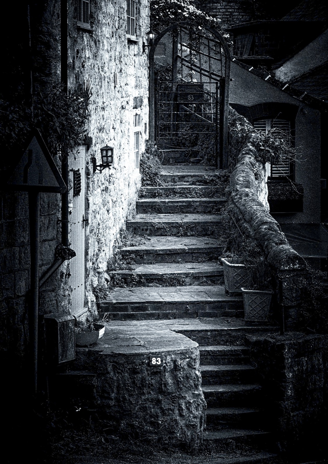 Worn stone steps climbing to an old gateway in shadow — Knaresborough castle grounds