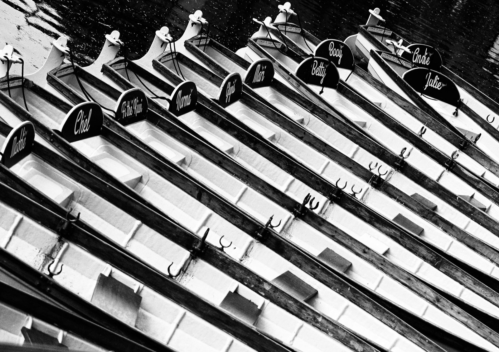 Ranks of upturned rowing boats lined up beside the River Nidd — Knaresborough boat hire