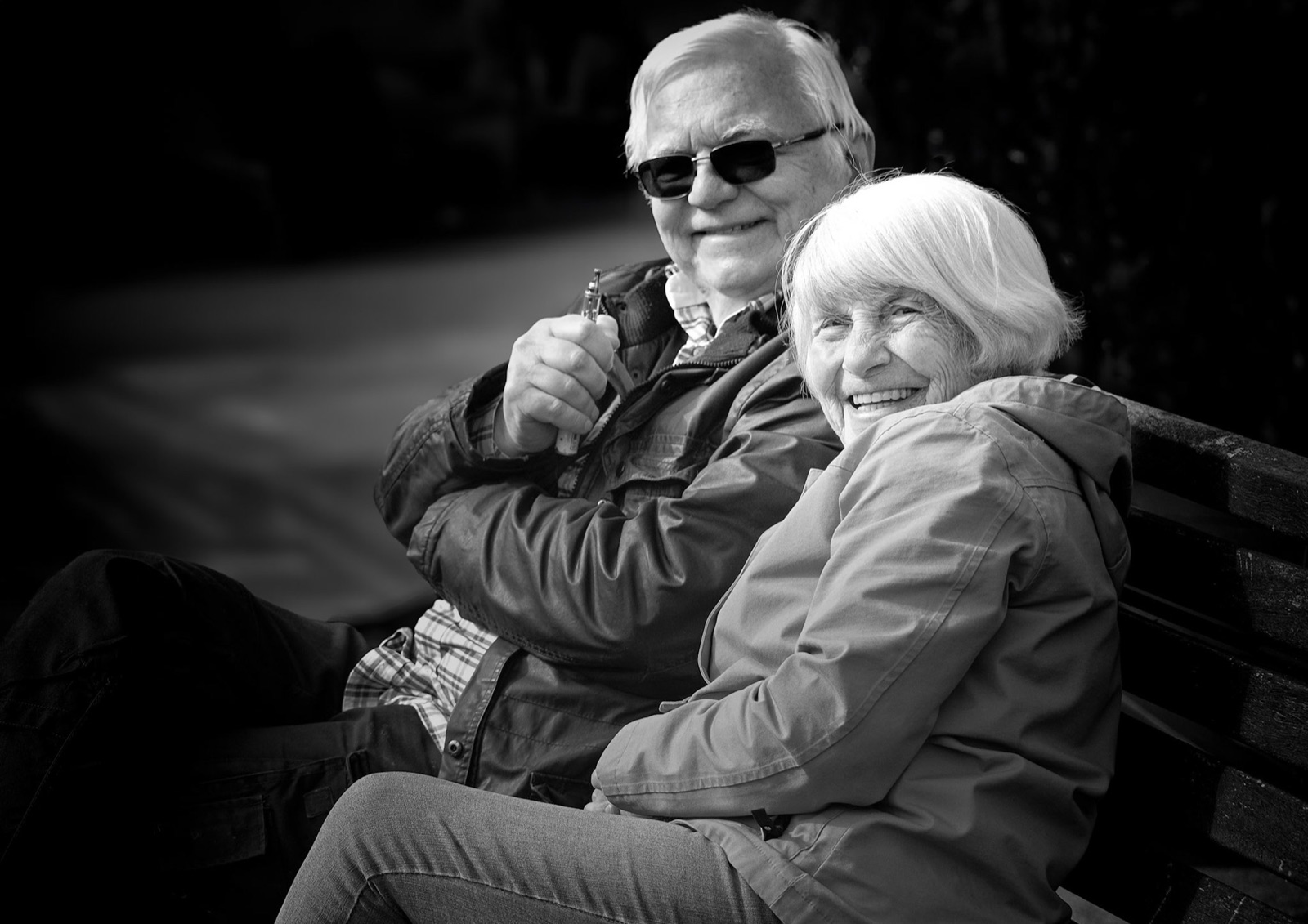 Older couple sharing a bench and a smile — candid Knaresborough portrait