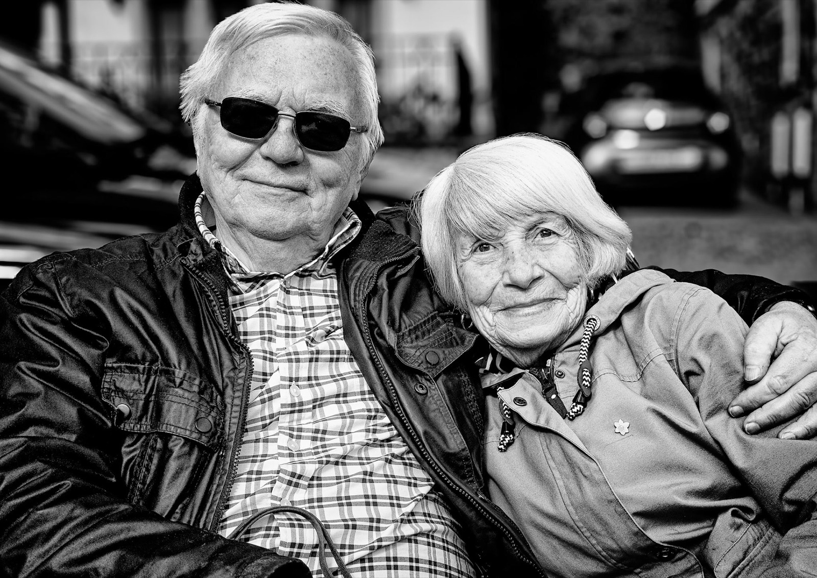 Older couple arm in arm, laughing together — candid Knaresborough street portrait
