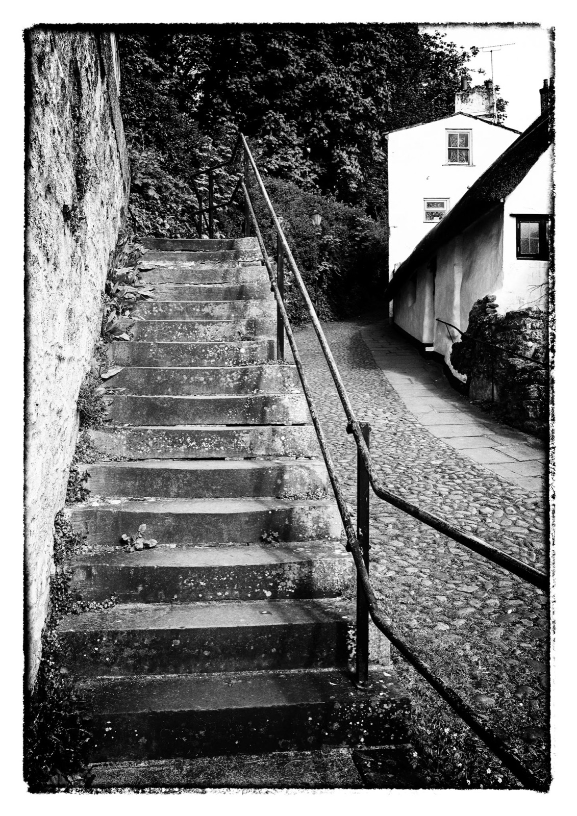 Worn steps and handrail climbing between cottages — Knaresborough hillside