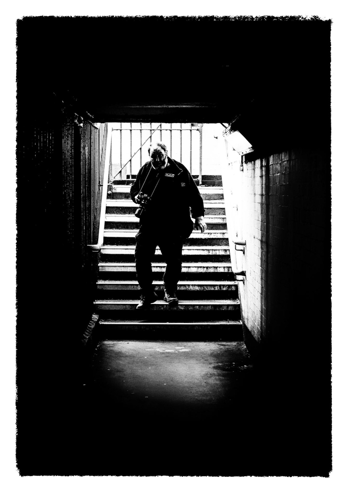 Silhouetted figure climbing steps out of a dark underpass — Knaresborough