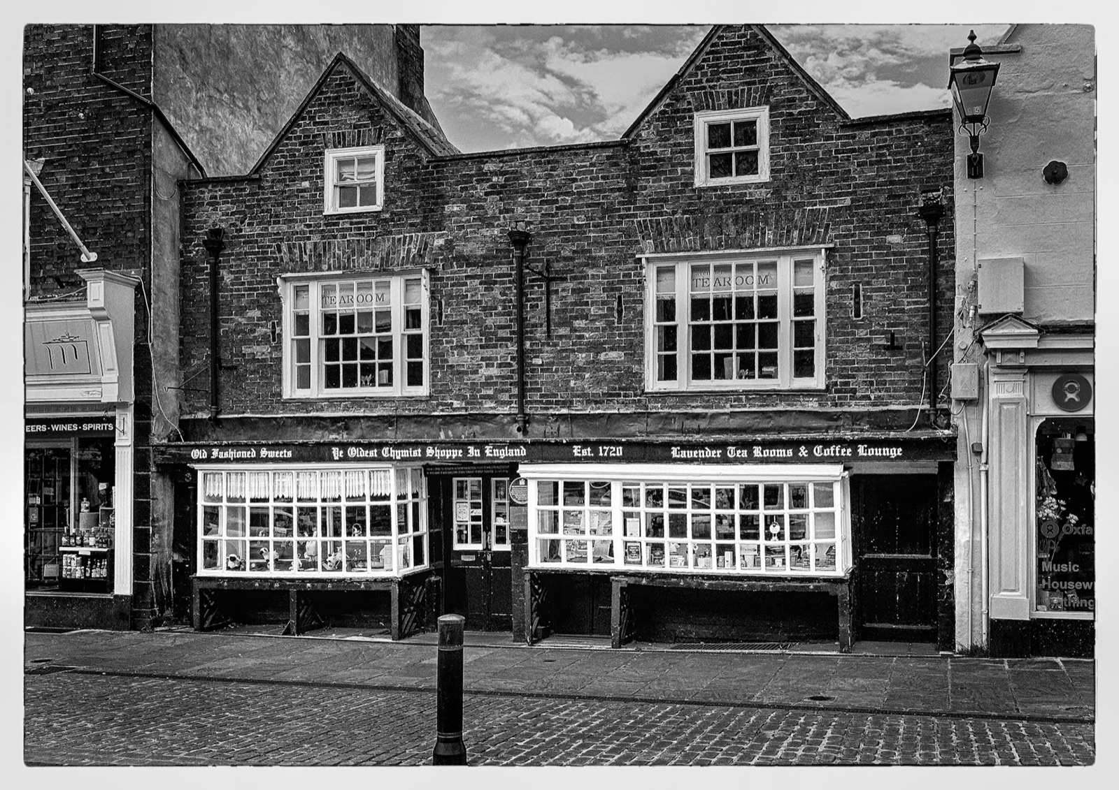 Row of market-place shopfronts on the cobbles — Knaresborough town centre
