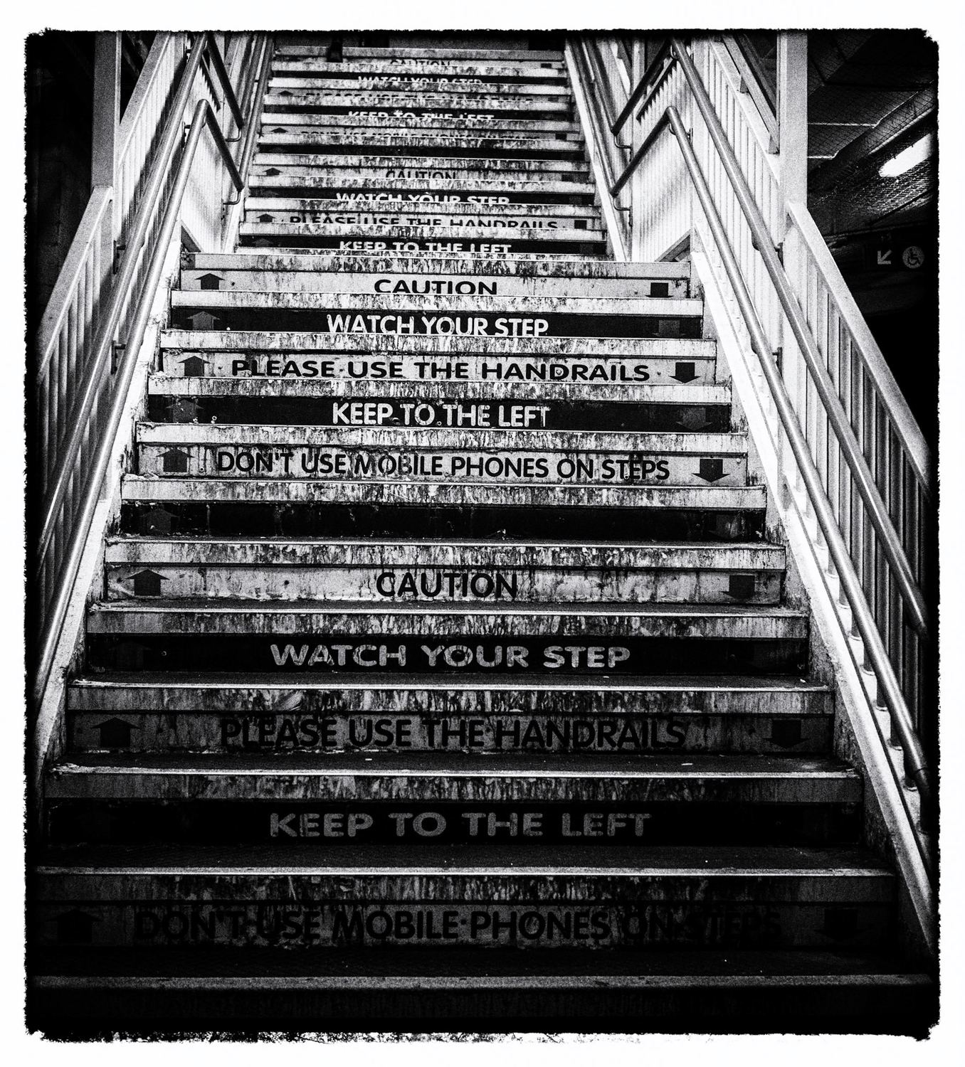 Graffiti-covered stairway with WATCH YOUR STEP painted on the risers — Leeds at night