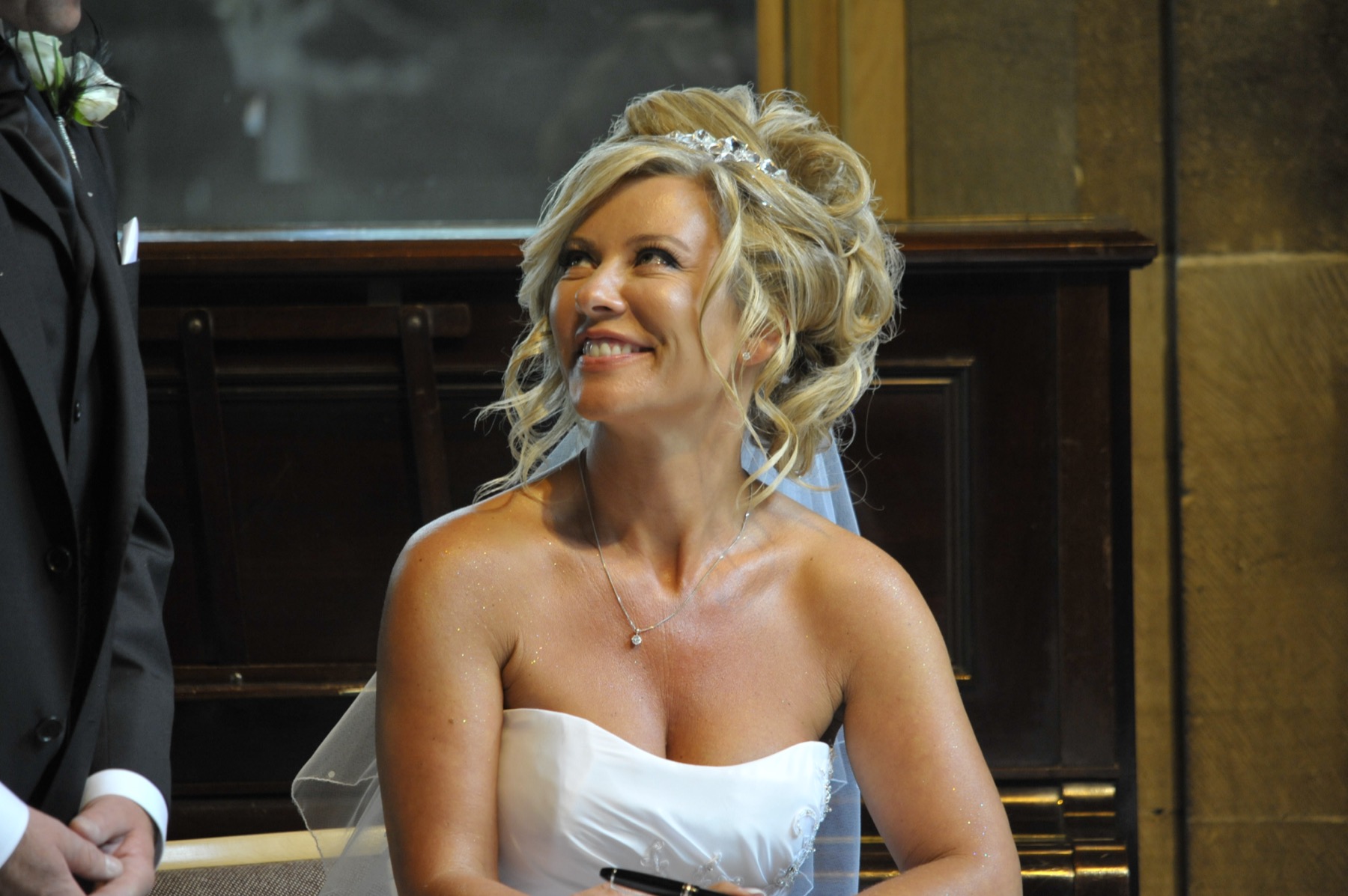 The bride during the ceremony, by the fireplace